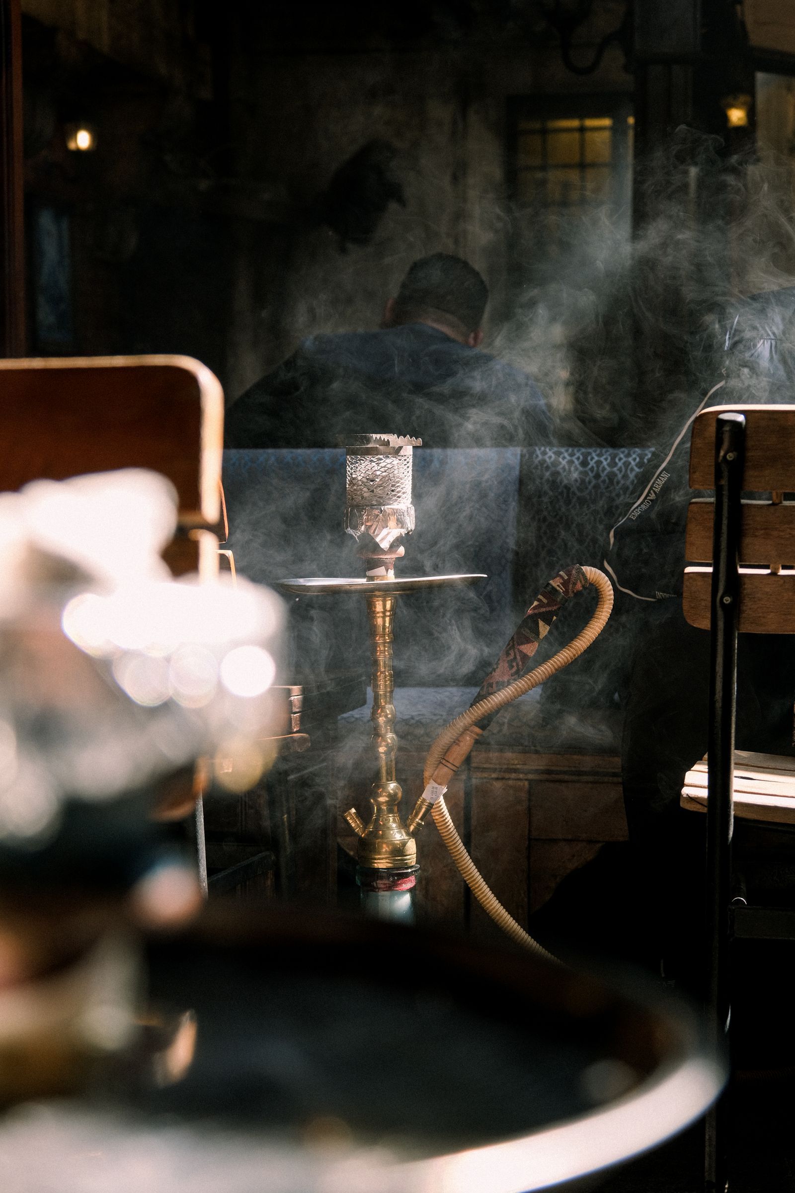 Atmospheric hookah lounge interior with warm amber lighting